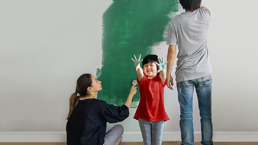 A family is painting a wall together; image used for HSBC Singapore Personal Loan